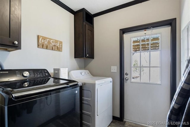 washroom featuring cabinet space, washing machine and dryer, and wood finished floors