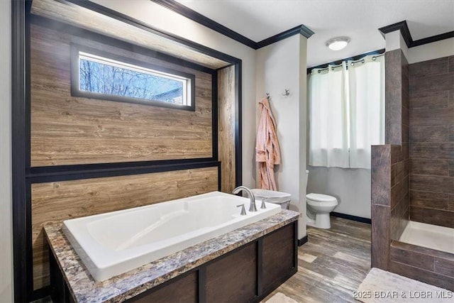 bathroom featuring crown molding, toilet, a bath, baseboards, and tiled shower