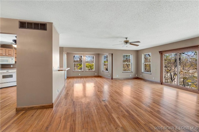 165 Four Winds Ct, Lake Ozark, MO 65049 - unfurnished living room featuring ceiling fan, a textured ceiling, healthy amount of natural light, and light wood-type flooring