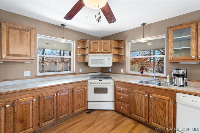 165 Four Winds Ct, Lake Ozark, MO 65049 - kitchen with white appliances, a sink, open shelves, tile counters, and brown cabinetry