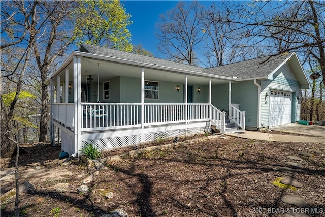 165 Four Winds Ct, Lake Ozark, MO 65049 - view of front of home featuring a porch, an attached garage, roof with shingles, and driveway