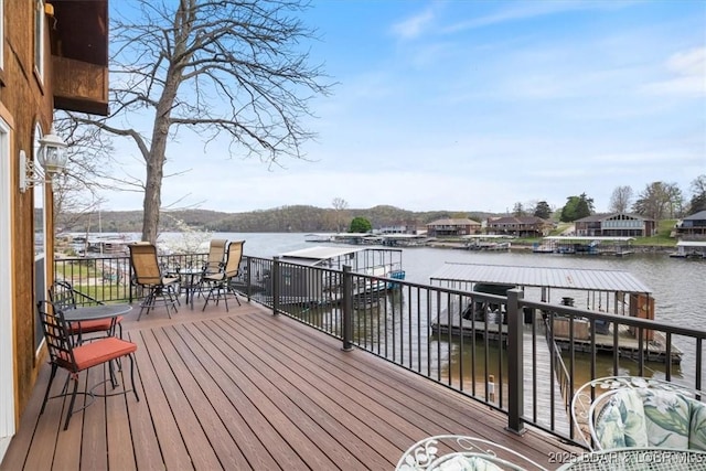 wooden terrace with a boat dock and a water view