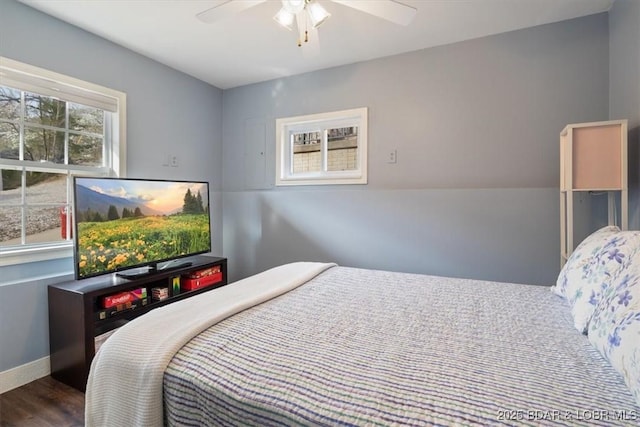 bedroom with wood finished floors, baseboards, and ceiling fan