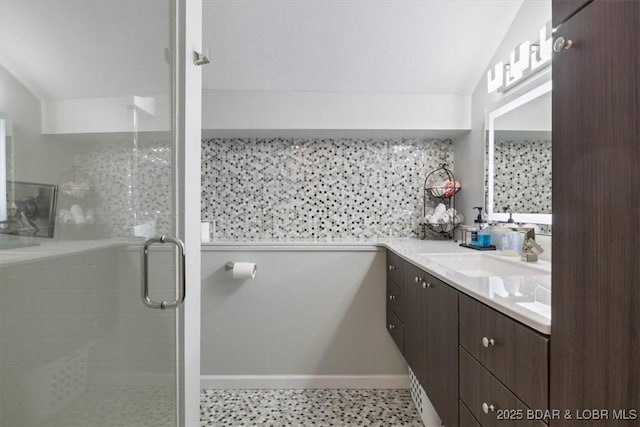 bathroom with decorative backsplash, vanity, and a shower stall