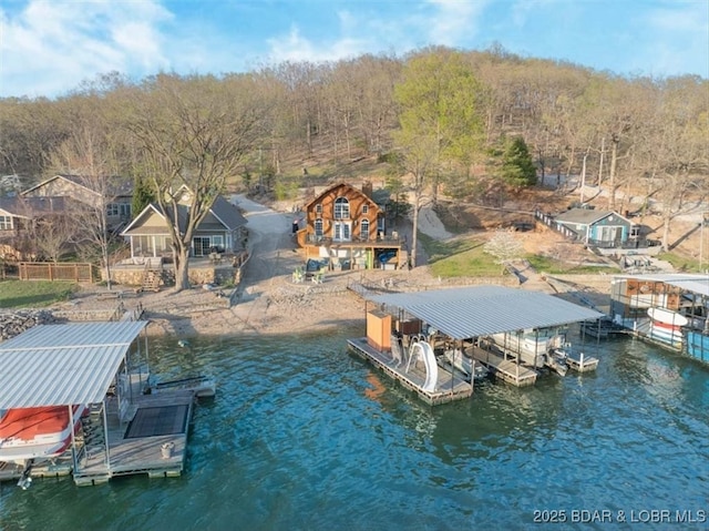 view of dock with boat lift and a water view