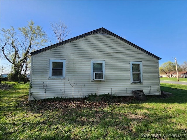 view of side of property with a lawn