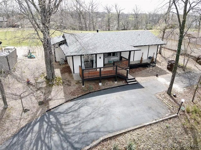 view of front of house with a wooden deck and a shingled roof