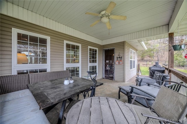 view of patio with a grill, outdoor dining space, and a ceiling fan