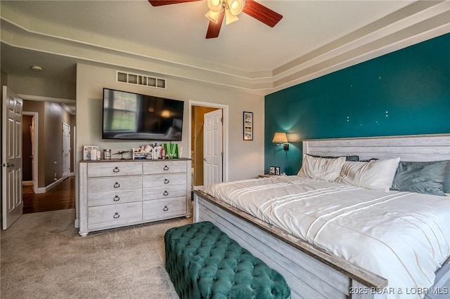 carpeted bedroom with visible vents and a ceiling fan