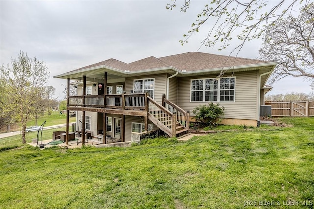 rear view of property with a patio, fence, and a lawn