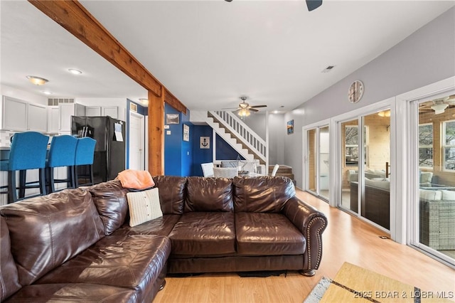 70 Ravenwood Dr, Lake Ozark, MO 65049 - living area featuring ceiling fan, light wood-style flooring, and stairway