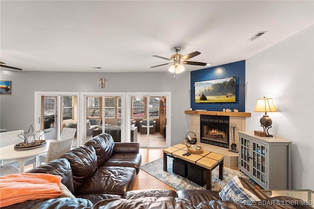 70 Ravenwood Dr, Lake Ozark, MO 65049 - living room featuring a ceiling fan, french doors, wood finished floors, and a tiled fireplace