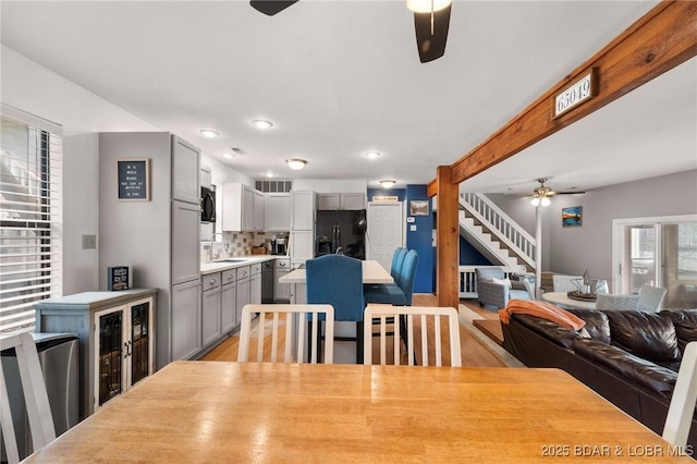 70 Ravenwood Dr, Lake Ozark, MO 65049 - dining area featuring ceiling fan, stairway, light wood finished floors, and recessed lighting