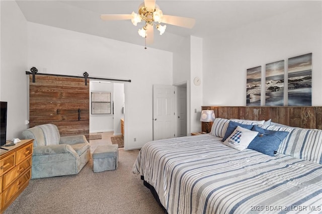 70 Ravenwood Dr, Lake Ozark, MO 65049 - carpeted bedroom featuring a barn door, a ceiling fan, and lofted ceiling