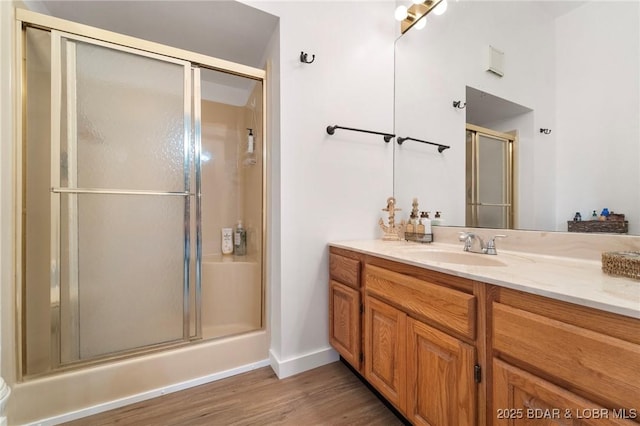 70 Ravenwood Dr, Lake Ozark, MO 65049 - full bathroom featuring an enclosed shower, vanity, and wood finished floors