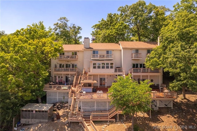 70 Ravenwood Dr, Lake Ozark, MO 65049 - back of property featuring stairs, a chimney, and a deck