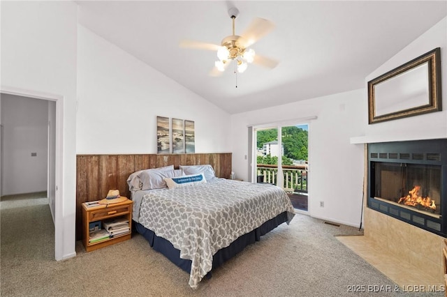 70 Ravenwood Dr, Lake Ozark, MO 65049 - carpeted bedroom featuring access to outside, lofted ceiling, a tiled fireplace, and a ceiling fan