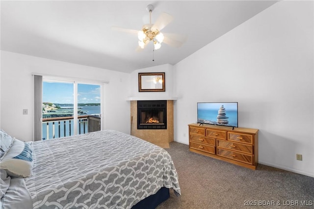 70 Ravenwood Dr, Lake Ozark, MO 65049 - bedroom featuring access to outside, carpet, lofted ceiling, a lit fireplace, and a ceiling fan