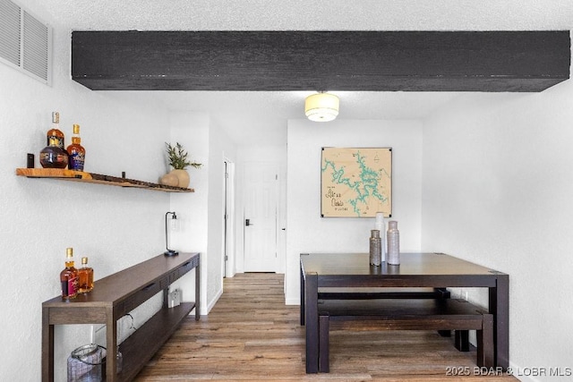 dining area featuring wood finished floors and visible vents