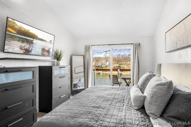 bedroom with access to exterior, lofted ceiling, and a water view