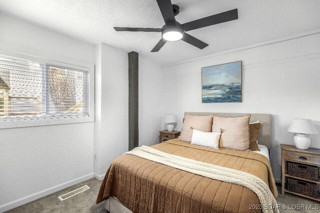 bedroom with baseboards, a ceiling fan, visible vents, and carpet floors