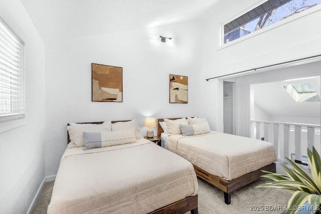 bedroom featuring high vaulted ceiling, multiple windows, carpet, and baseboards