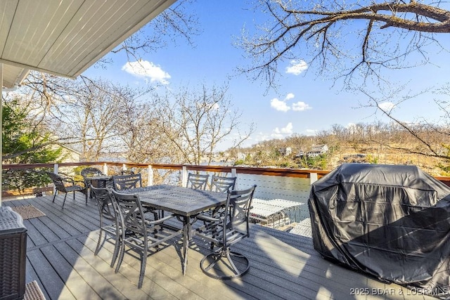 deck featuring area for grilling and outdoor dining area
