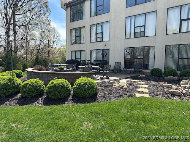 429-1D Racquet Club Dr Unit 1D, Four Seasons, MO 65049 - back of property with a patio area, a yard, and stucco siding