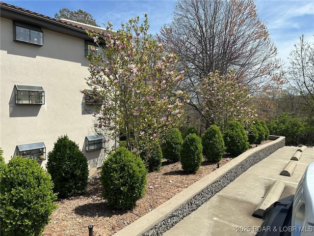 429-1D Racquet Club Dr Unit 1D, Four Seasons, MO 65049 - view of side of home featuring stucco siding and a tile roof