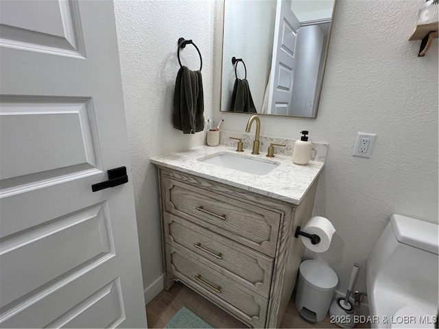 bathroom featuring toilet and vanity