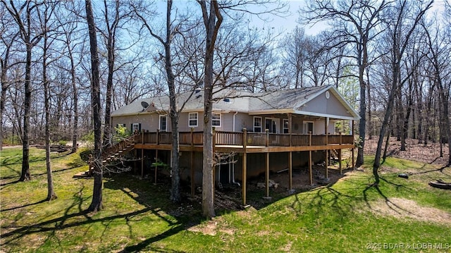rear view of house featuring a wooden deck, a yard, and stairway