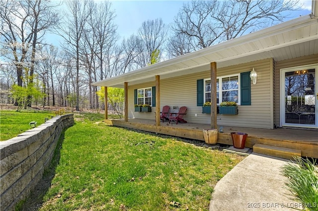 back of house with a lawn and covered porch