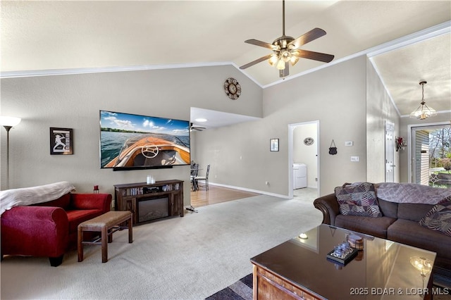 living area featuring baseboards, ornamental molding, carpet flooring, and ceiling fan