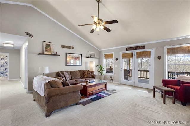 living area featuring visible vents, light carpet, baseboards, ceiling fan, and high vaulted ceiling