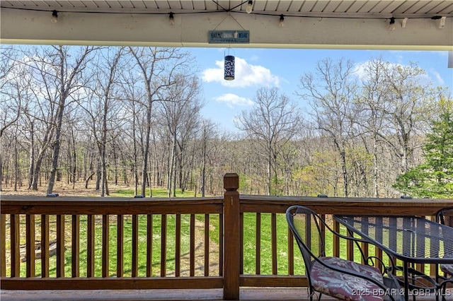 exterior space with a deck and a forest view
