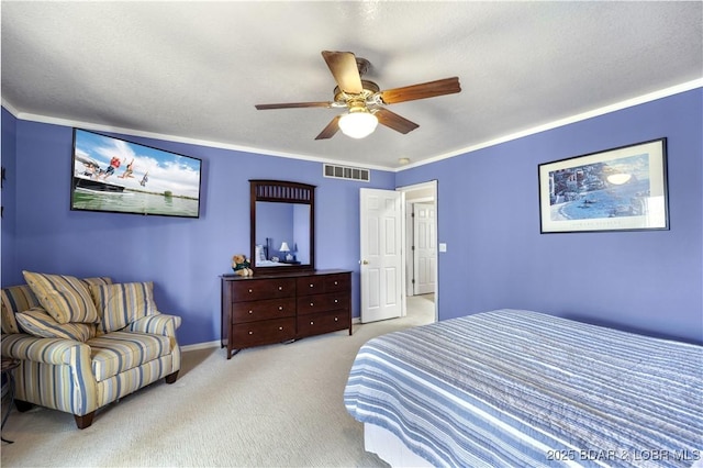 bedroom featuring crown molding, ceiling fan, carpet, baseboards, and visible vents