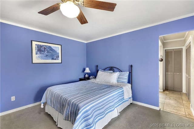 carpeted bedroom featuring baseboards, ornamental molding, and a ceiling fan