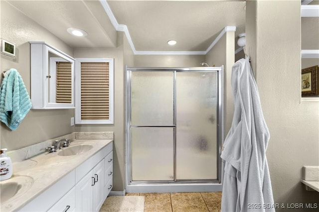 full bath with a sink, tile patterned flooring, a stall shower, and double vanity