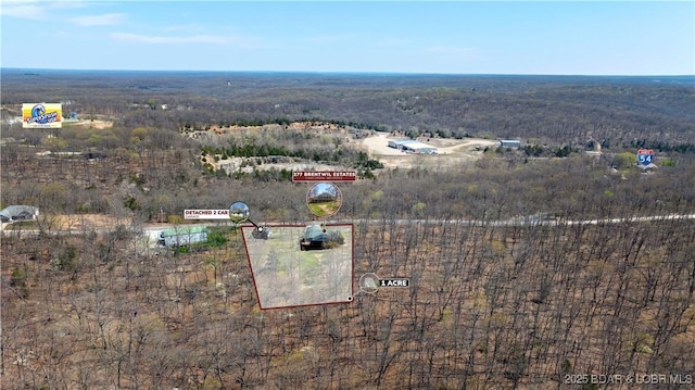 birds eye view of property featuring a view of trees