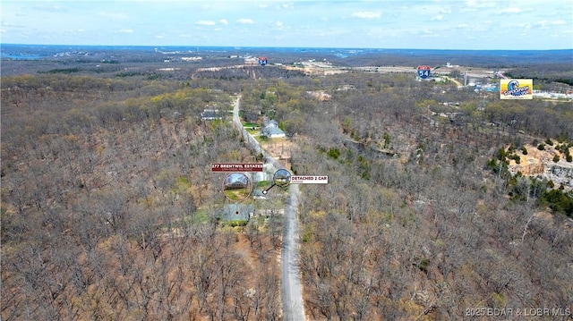 bird's eye view featuring a wooded view