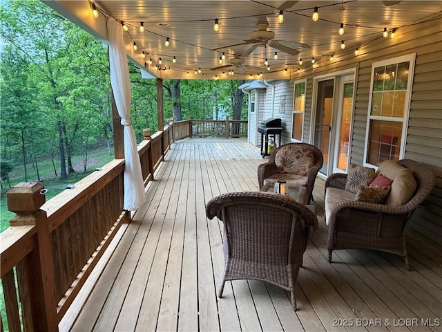 deck with a ceiling fan and grilling area