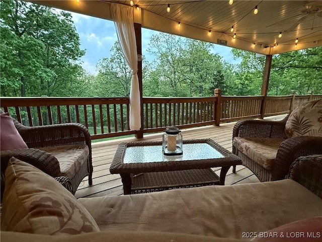 wooden deck with an outdoor living space