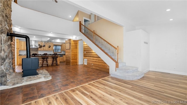 15 Rose Wind Ln, Brumley, MO 65017 - living area featuring stairs, a wood stove, recessed lighting, light wood-style flooring, and baseboards
