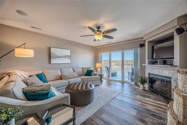1359 Seascape Ln Unit A-501, Osage Beach, MO 65065 - living area featuring a glass covered fireplace, a ceiling fan, and wood finished floors
