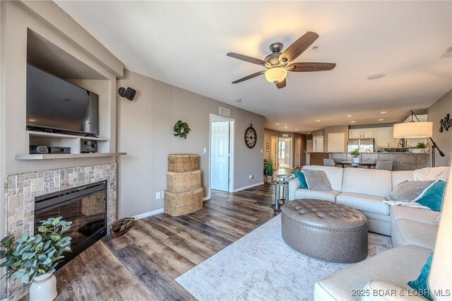 1359 Seascape Ln Unit A-501, Osage Beach, MO 65065 - living room featuring a tile fireplace, wood finished floors, a ceiling fan, baseboards, and recessed lighting