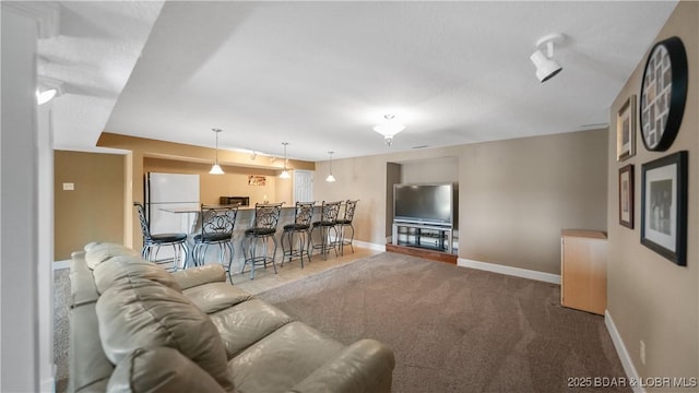 living area featuring carpet floors and baseboards