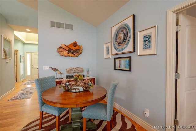5218 Big Ship St, Osage Beach, MO 65065 - dining room featuring visible vents, baseboards, recessed lighting, vaulted ceiling, and wood finished floors