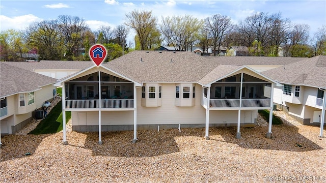 5218 Big Ship St, Osage Beach, MO 65065 - rear view of property featuring central AC unit, a sunroom, and roof with shingles