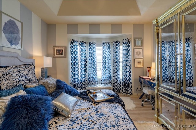 5218 Big Ship St, Osage Beach, MO 65065 - bedroom featuring a tray ceiling and light wood-style floors