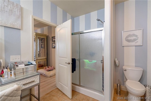 5218 Big Ship St, Osage Beach, MO 65065 - bathroom featuring toilet, a stall shower, wallpapered walls, baseboards, and tile patterned floors